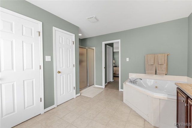 bathroom featuring ensuite bath, a jetted tub, baseboards, visible vents, and a stall shower