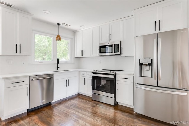 kitchen with visible vents, a sink, light countertops, and stainless steel appliances