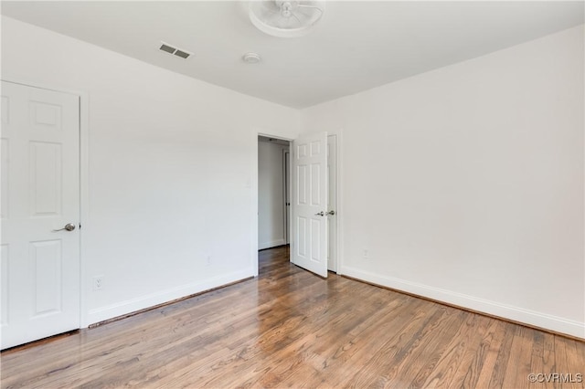 interior space with visible vents, baseboards, and wood finished floors