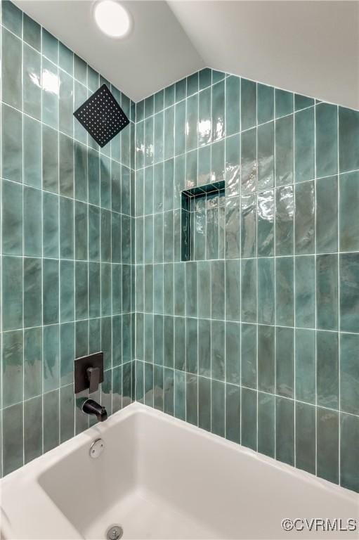 bathroom featuring shower / bathtub combination and vaulted ceiling