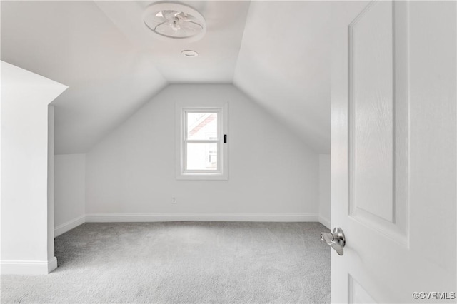 additional living space featuring baseboards, carpet flooring, and lofted ceiling