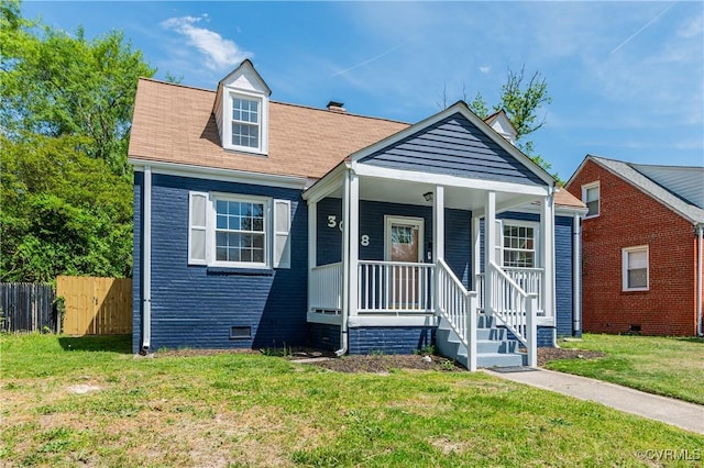bungalow-style house with fence, covered porch, a front yard, and crawl space