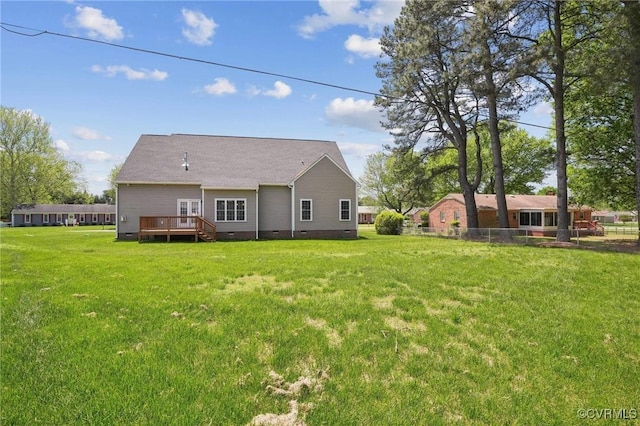 rear view of house featuring a lawn, crawl space, and a wooden deck