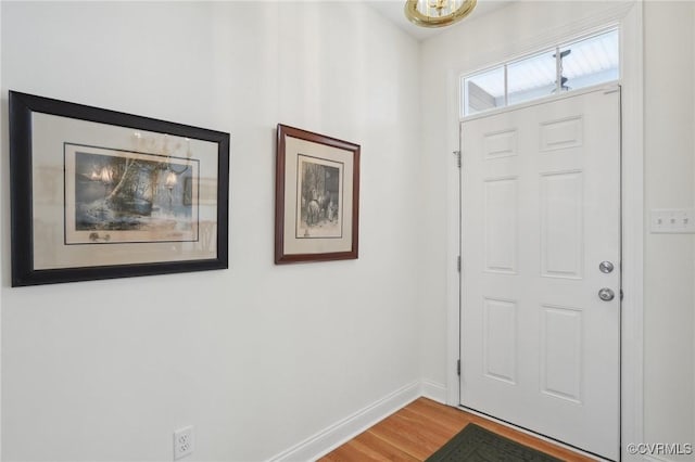 foyer entrance featuring light wood-style flooring and baseboards