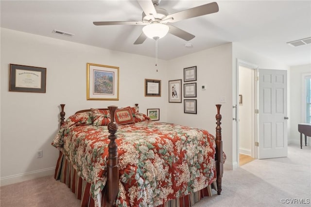 bedroom featuring visible vents, baseboards, and light carpet