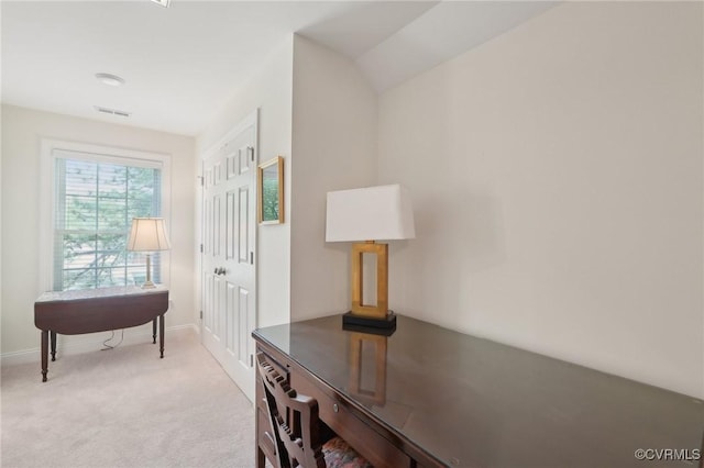 interior space featuring visible vents, light carpet, and baseboards