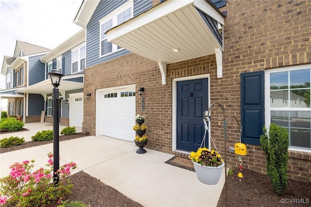 11513 Dunmore Mill Ter Unit 3-4, Chester, VA 23831 - property entrance with a garage, driveway, and brick siding