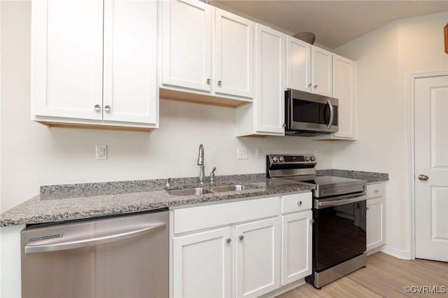 11513 Dunmore Mill Ter Unit 3-4, Chester, VA 23831 - kitchen with a sink, light stone counters, light wood finished floors, stainless steel appliances, and white cabinetry