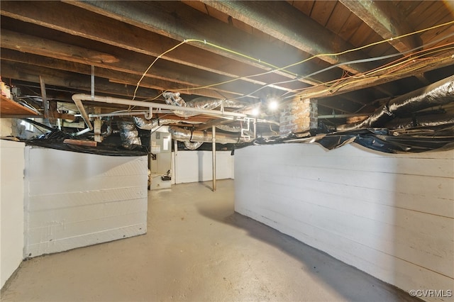 unfinished basement featuring heating unit