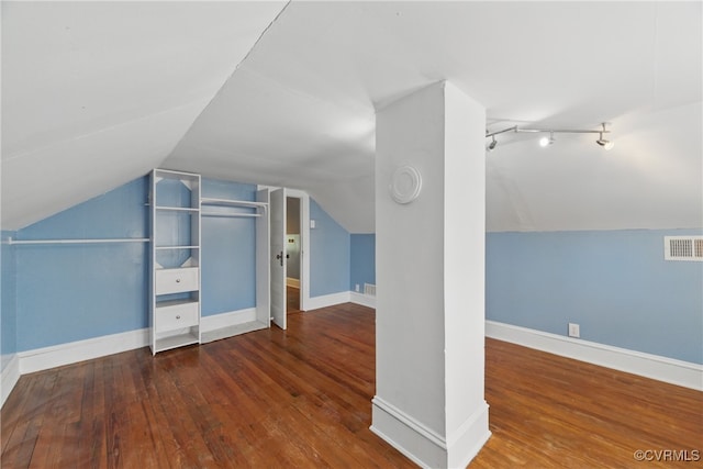 bonus room with visible vents, vaulted ceiling, hardwood / wood-style flooring, and baseboards