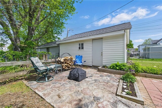 view of patio featuring an outdoor fire pit and fence