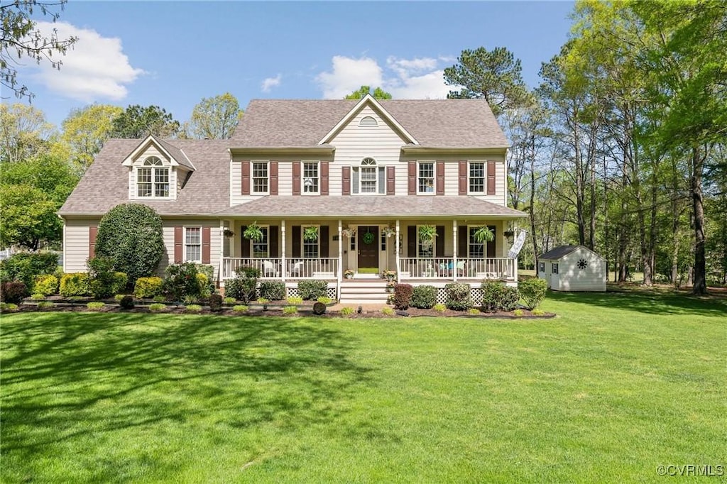8412 Royal Birkdale Dr, Chesterfield, VA 23832 - view of front facade featuring covered porch, an outdoor structure, a front yard, and a storage shed