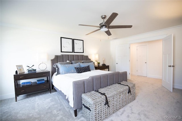 bedroom with crown molding, a ceiling fan, carpet floors, and baseboards