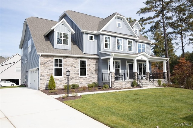 craftsman house with driveway, stone siding, a porch, a front lawn, and a garage