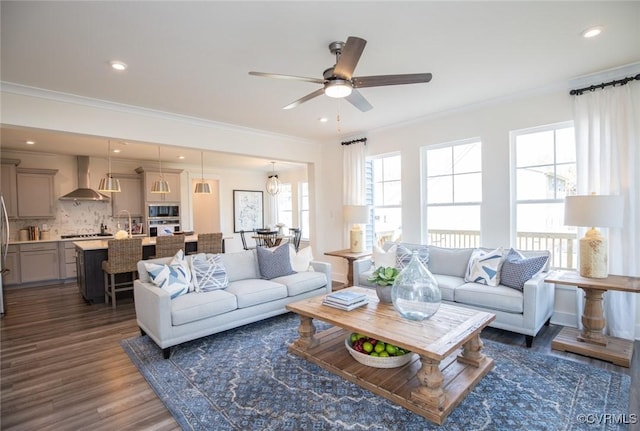 living area featuring crown molding, recessed lighting, a ceiling fan, and dark wood-style flooring
