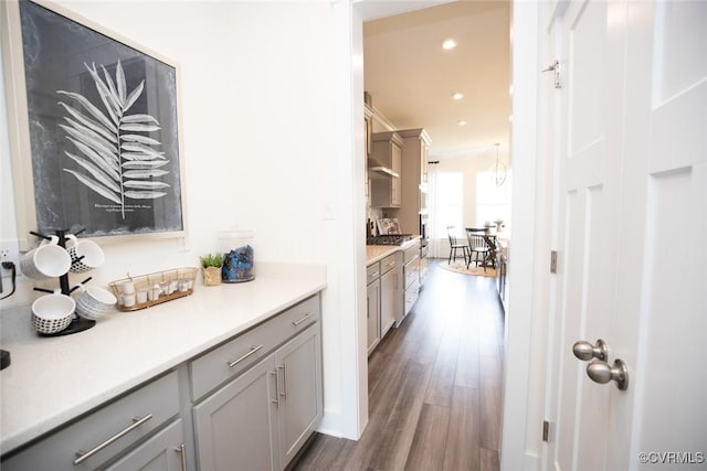 bar featuring recessed lighting, gas range, and dark wood-style flooring