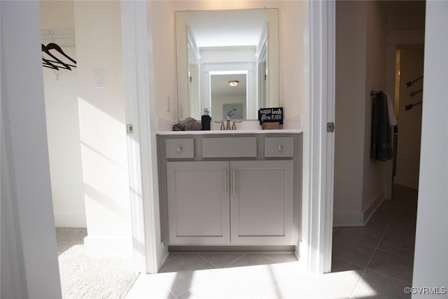 interior space featuring tile patterned flooring, vanity, and baseboards