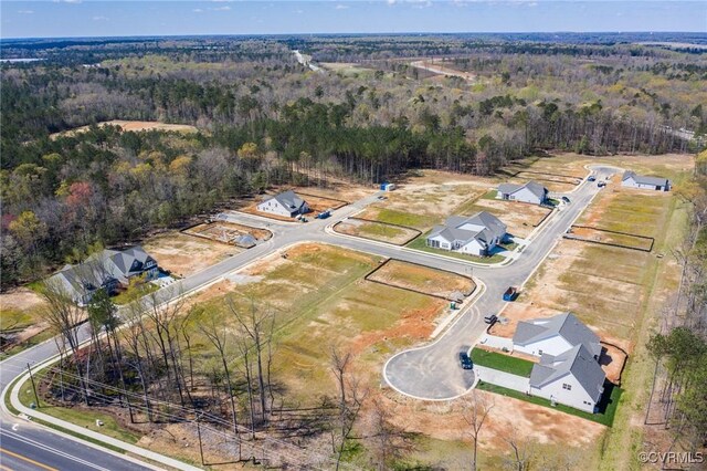 birds eye view of property with a forest view
