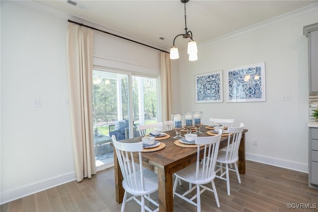 dining space with wood finished floors, visible vents, ornamental molding, and baseboards