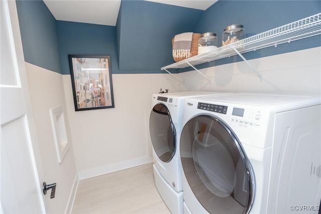washroom featuring baseboards, laundry area, and independent washer and dryer