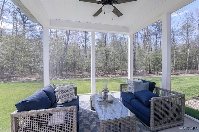 sunroom with an outdoor living space and a ceiling fan
