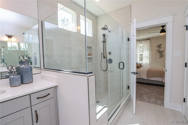 bathroom with a wealth of natural light, ceiling fan, vanity, and a stall shower