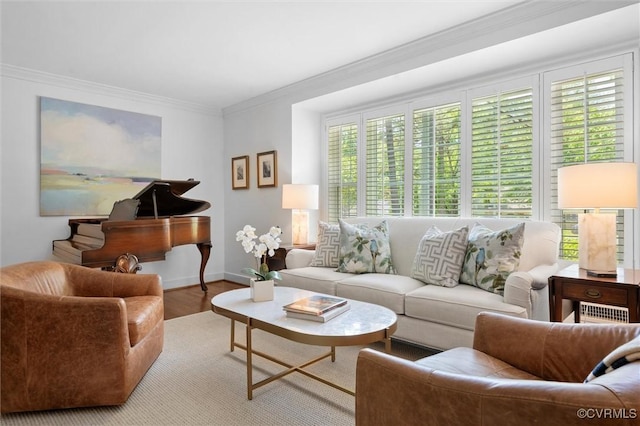 living room featuring crown molding, baseboards, and wood finished floors