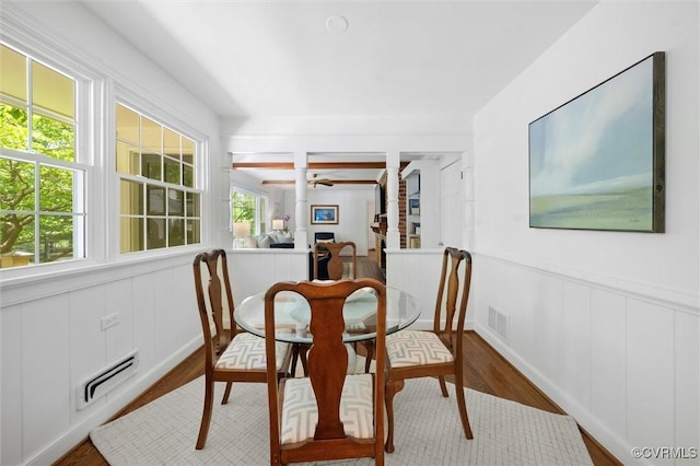 dining area with a healthy amount of sunlight, wood finished floors, and visible vents