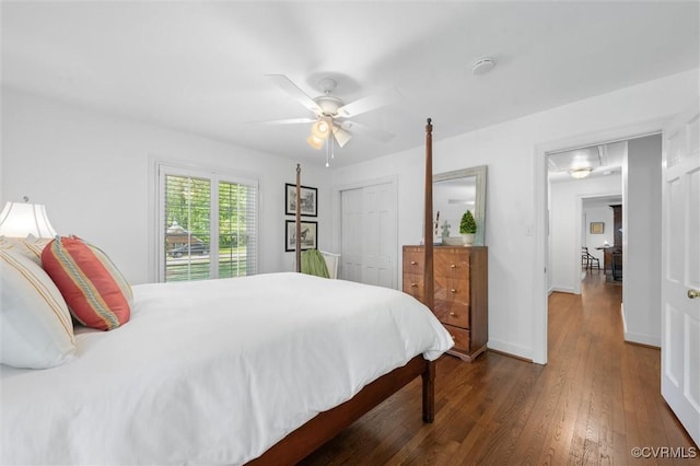 bedroom featuring a closet, baseboards, ceiling fan, and wood finished floors