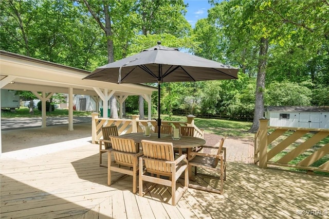 deck with an outbuilding and outdoor dining space