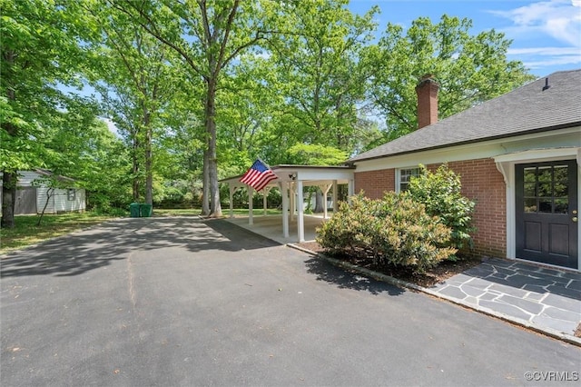 exterior space featuring a carport and driveway