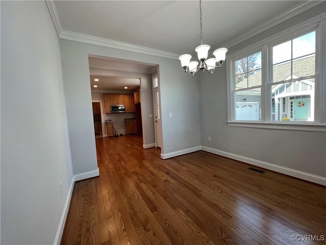 unfurnished dining area featuring crown molding, a notable chandelier, and dark wood-style floors