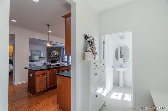 interior space with recessed lighting, a sink, and baseboards