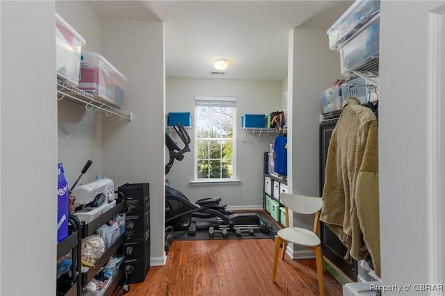 walk in closet with wood finished floors and visible vents
