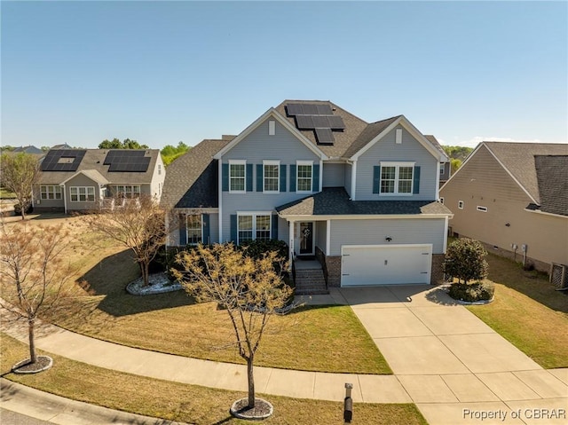 view of front of house with roof mounted solar panels, concrete driveway, a front lawn, brick siding, and a garage