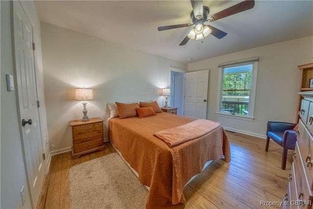 bedroom featuring hardwood / wood-style floors, baseboards, and a ceiling fan
