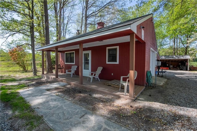 view of outbuilding with covered porch