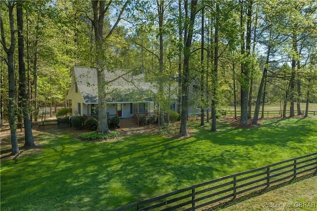 view of yard with a porch and fence