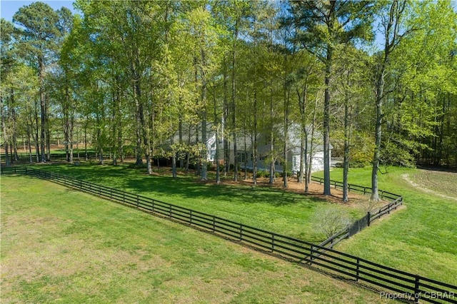 view of home's community featuring a lawn and fence