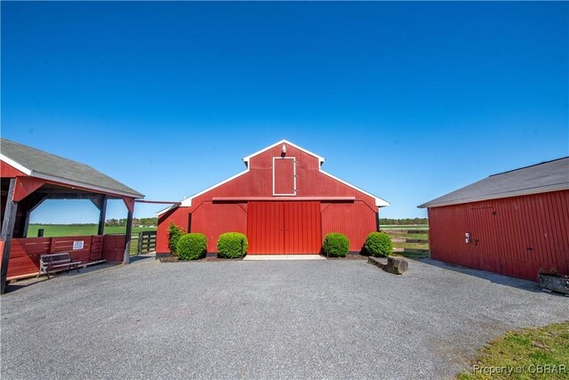 view of barn with fence