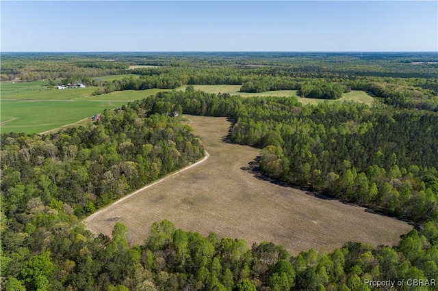 birds eye view of property with a view of trees