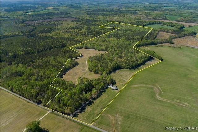 drone / aerial view featuring a forest view
