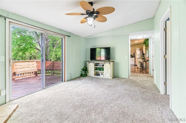 unfurnished living room with carpet, a ceiling fan, and lofted ceiling