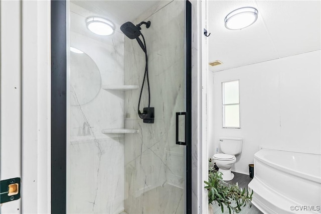 full bathroom with toilet and a marble finish shower