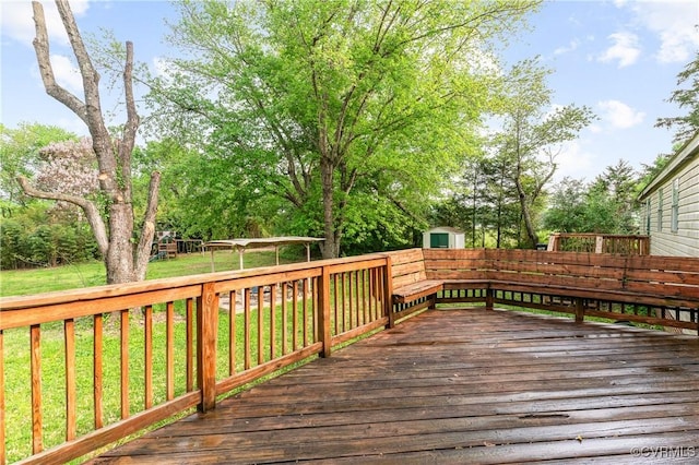wooden terrace featuring a yard