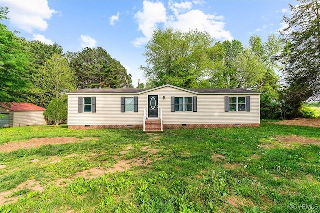 manufactured / mobile home with entry steps, a front lawn, and crawl space