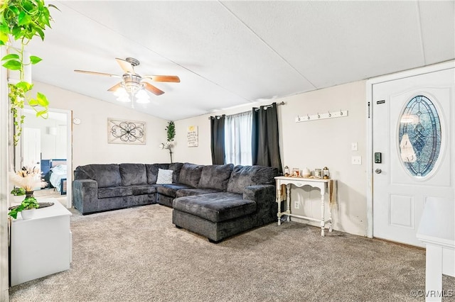carpeted living area featuring ceiling fan and vaulted ceiling