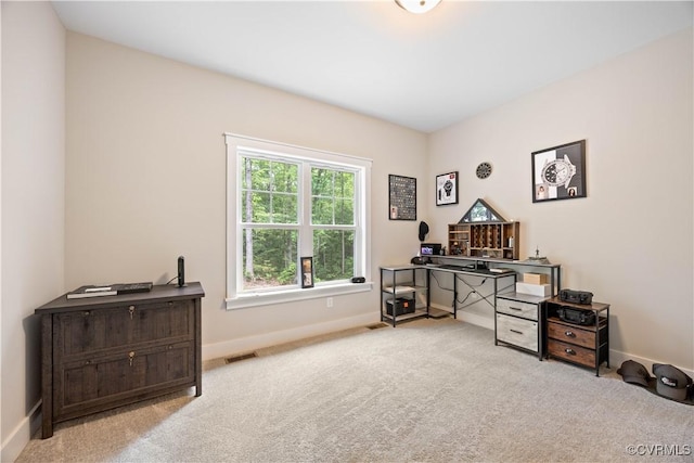 carpeted office with baseboards and visible vents