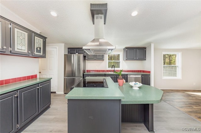 1223 Ullainee Rd, Essex, VA 22436 - kitchen with appliances with stainless steel finishes, light wood-style flooring, a sink, a center island, and a textured ceiling