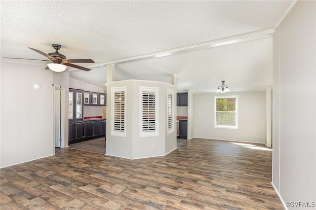 1223 Ullainee Rd, Essex, VA 22436 - unfurnished room featuring vaulted ceiling, dark wood-style flooring, a ceiling fan, a textured ceiling, and crown molding